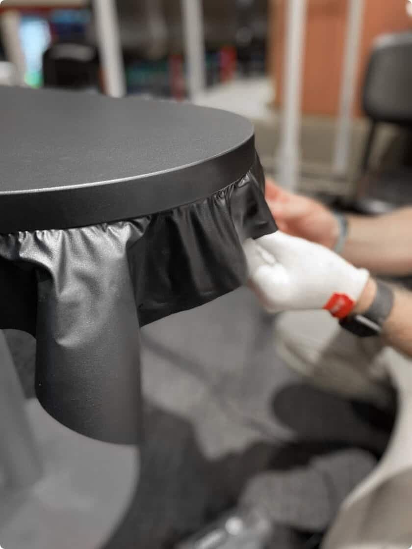 Black architectural vinyl applied by a gloved installer