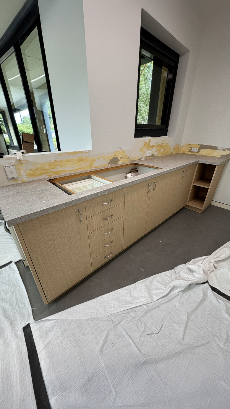 Yellow laminate cabinetry into natural timber after