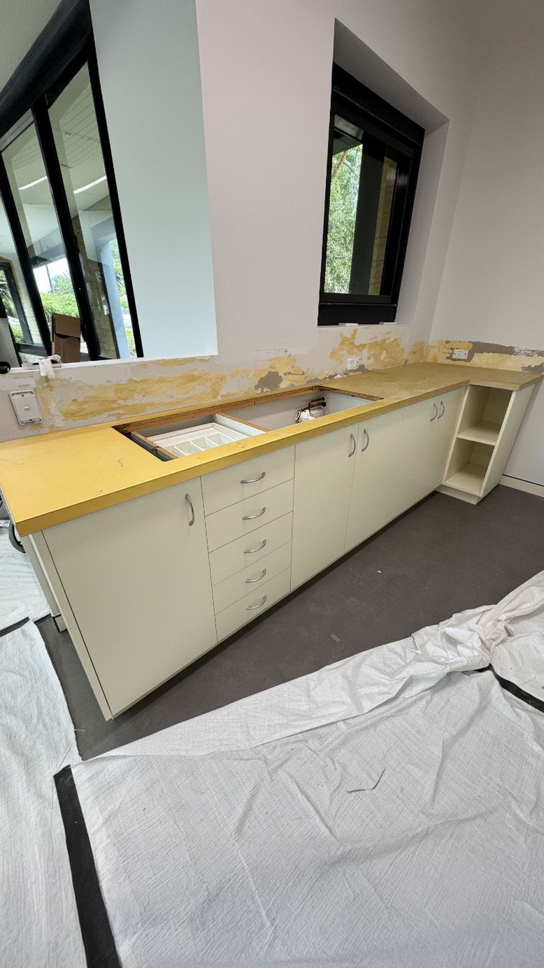 Yellow laminate cabinetry into natural timber before