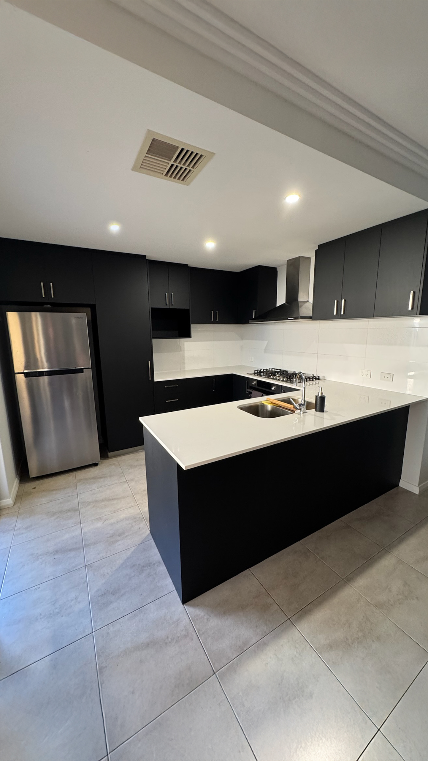 Cream gloss cabinets refreshed in matte black after