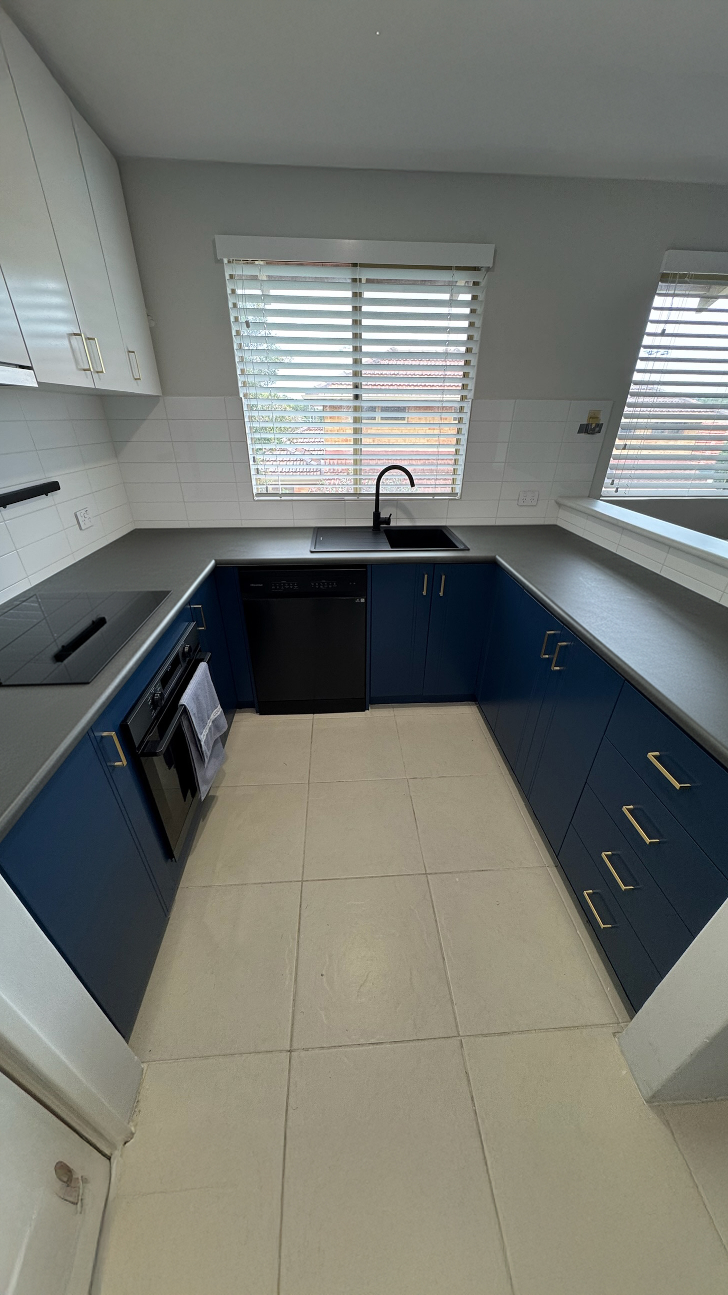 Benchtop-only wrap over a navy kitchen before