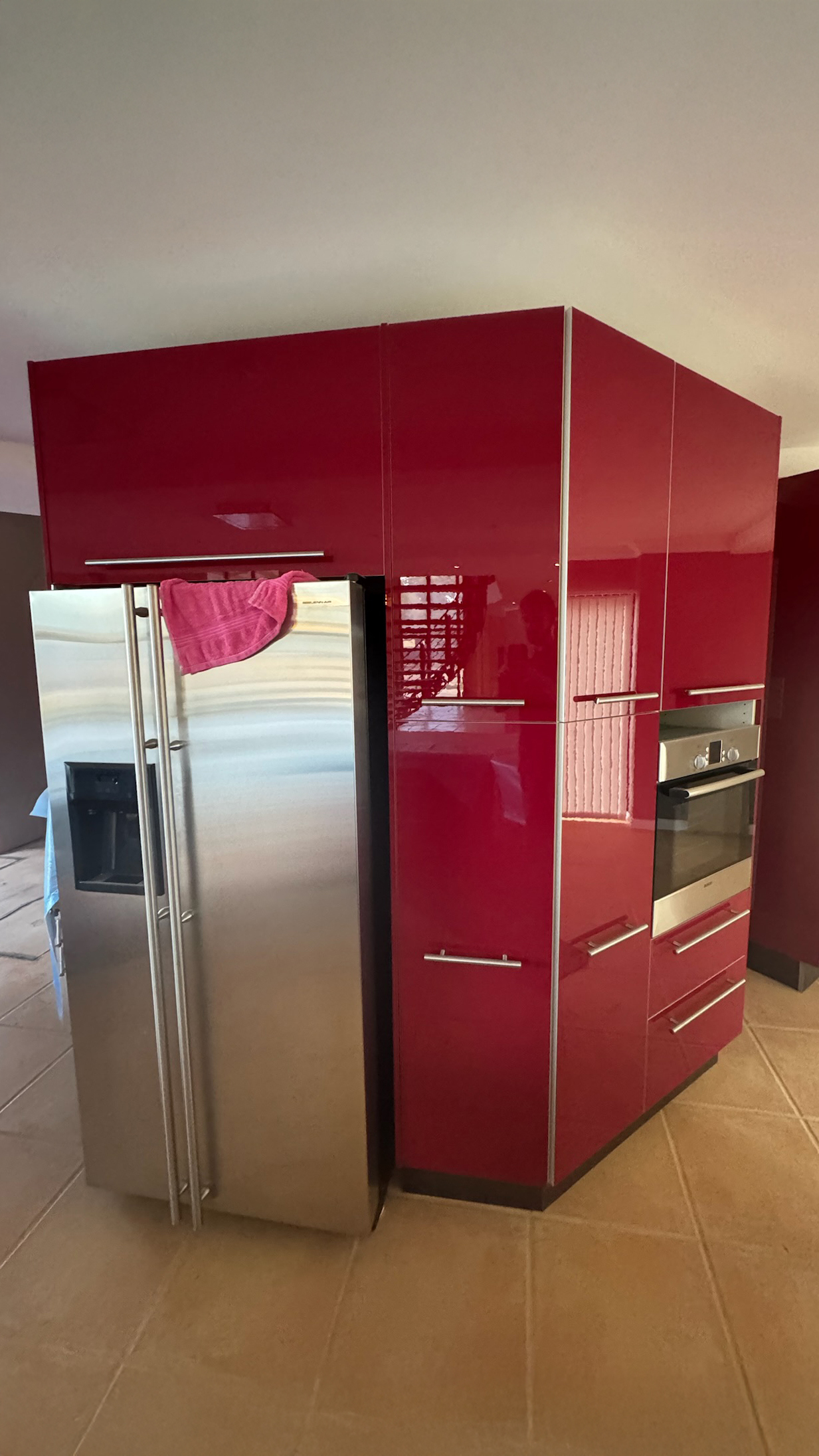 High-gloss red pantry taken back to crisp white before